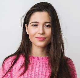 woman with long hair in pink sweater